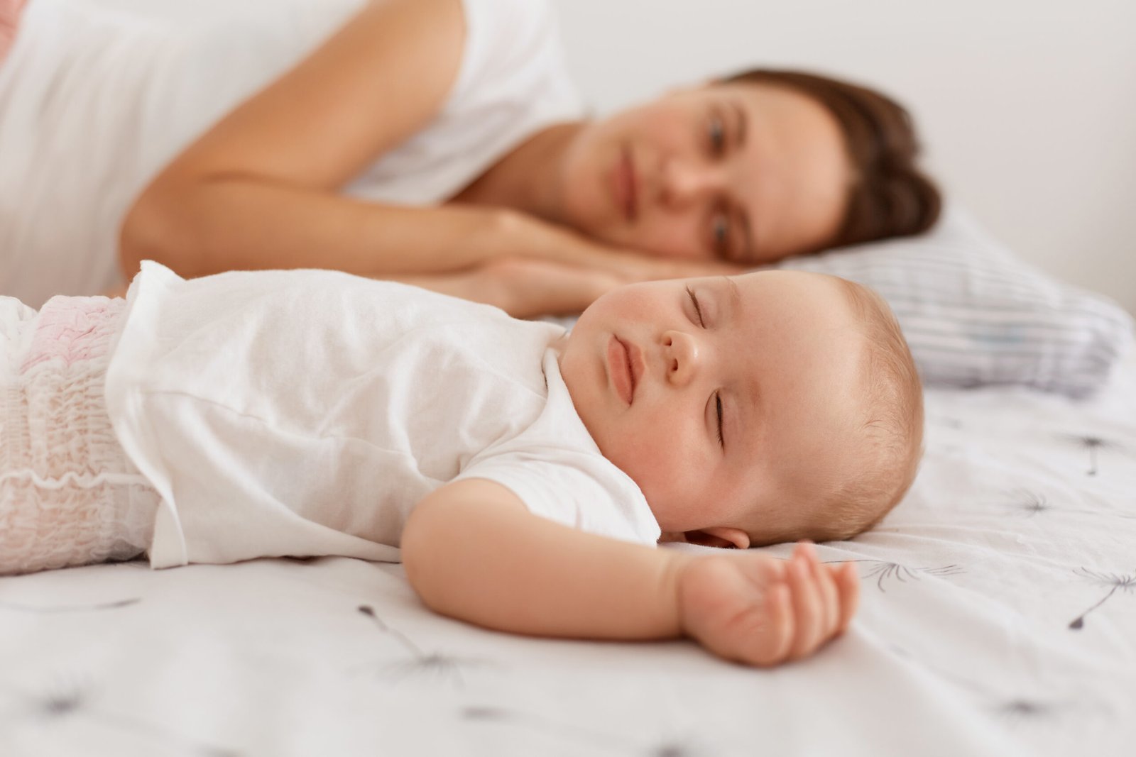 Parent gently placing baby on their back to follow safe sleep guidelines – baby rolling over tips to reduce risks.