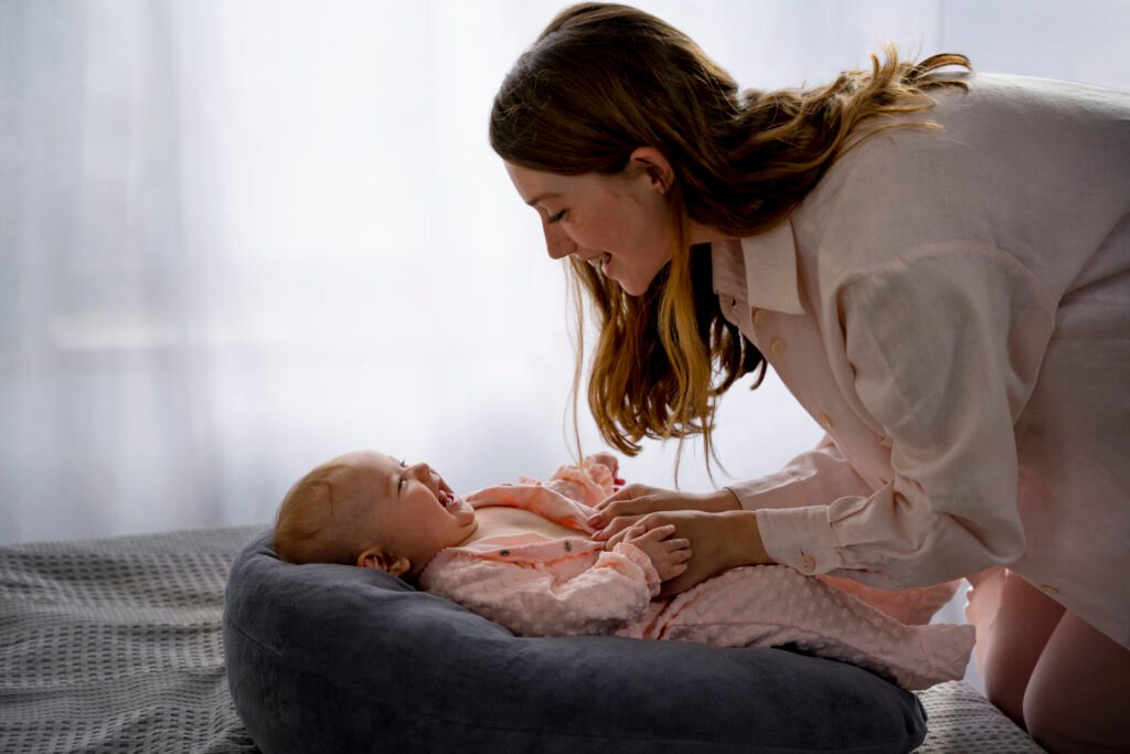 Mother soothing baby during light sleep phase, part of baby sleep cycles explained in understanding sleep associations