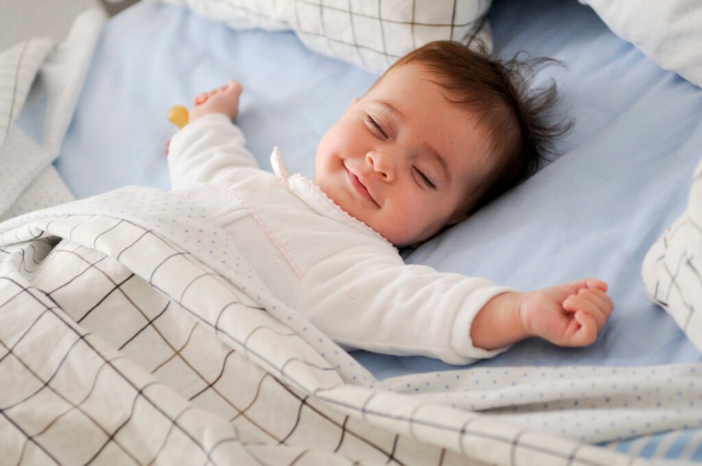 Peacefully sleeping baby showing natural baby sleep cycles explained in the blog