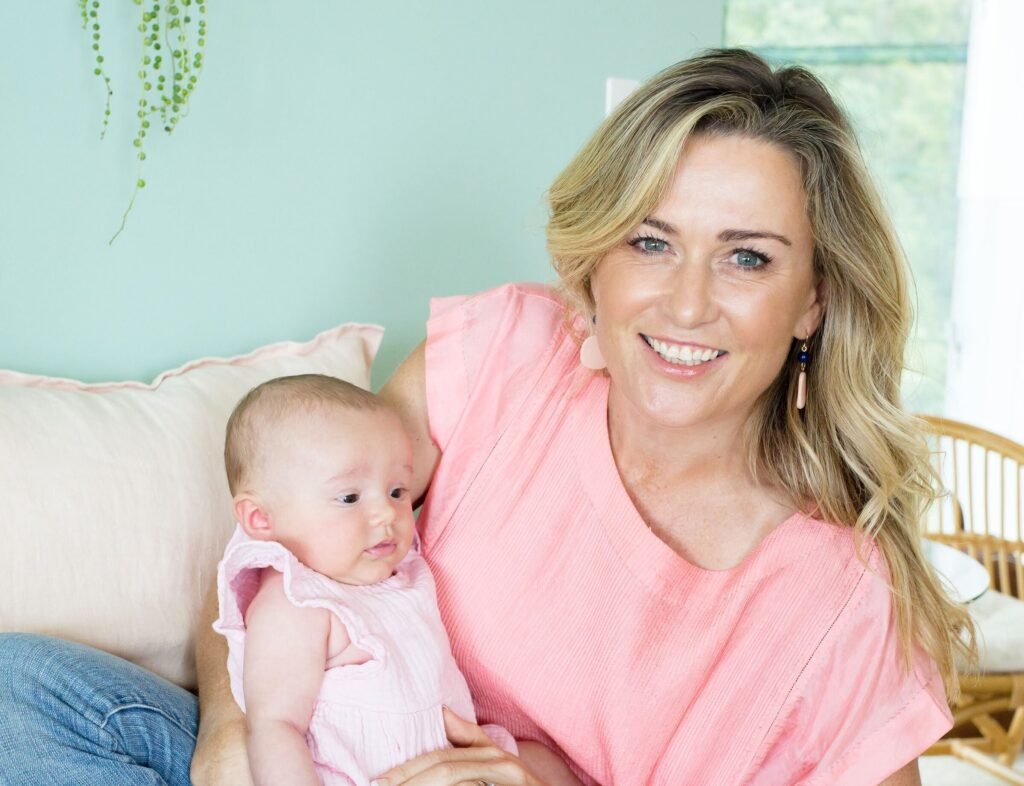 Elaine holding a baby during consultation