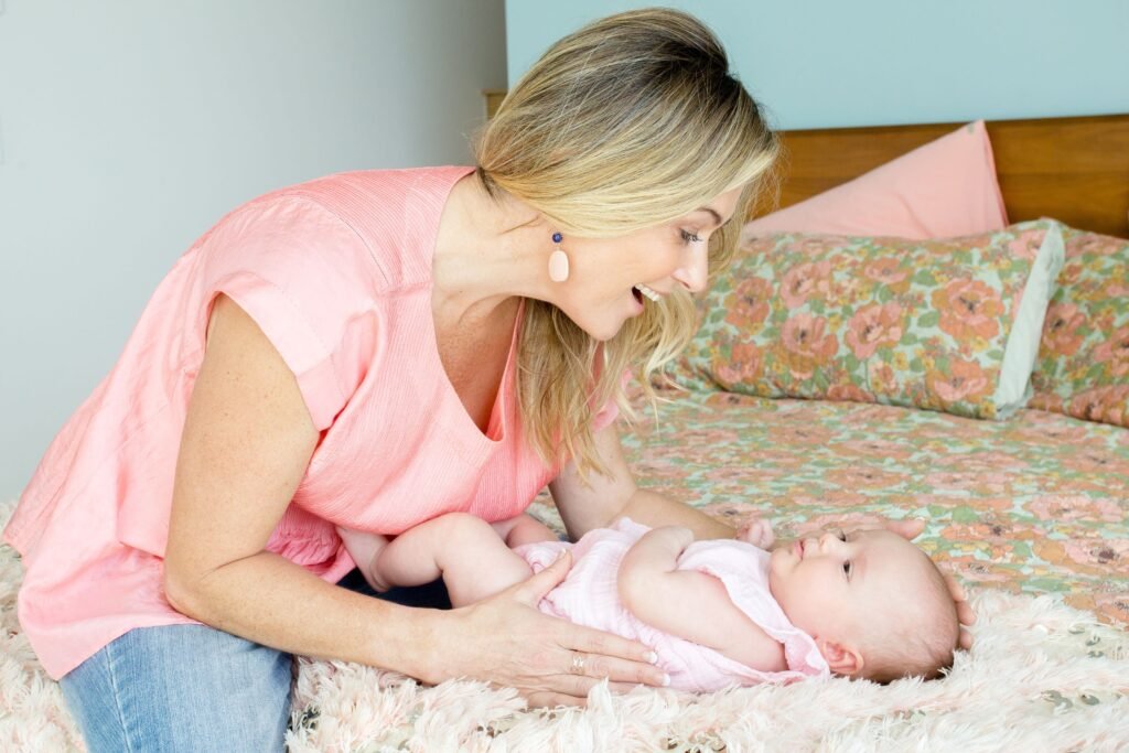 Elaine Harvey connecting with a baby through play and eye contact, demonstrating her attachment-based approach to building trust and confidence