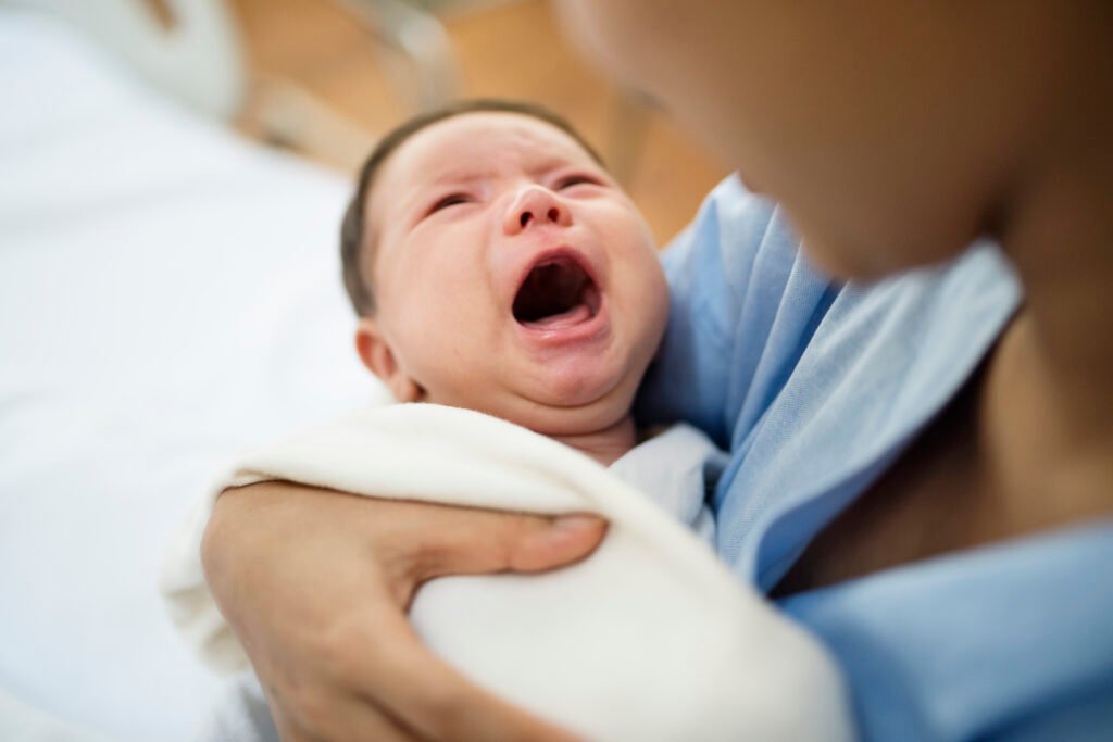 Mother Comforting a colic-overstimulated baby
