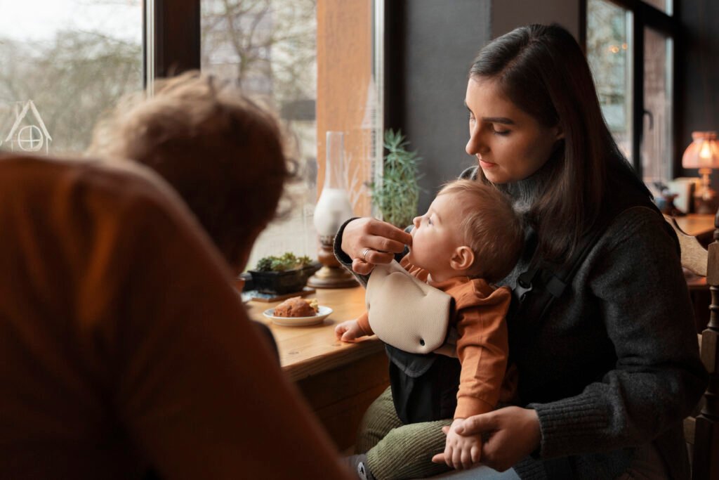 Mother introducing allergy-safe foods to baby in a calm, supportive setting.