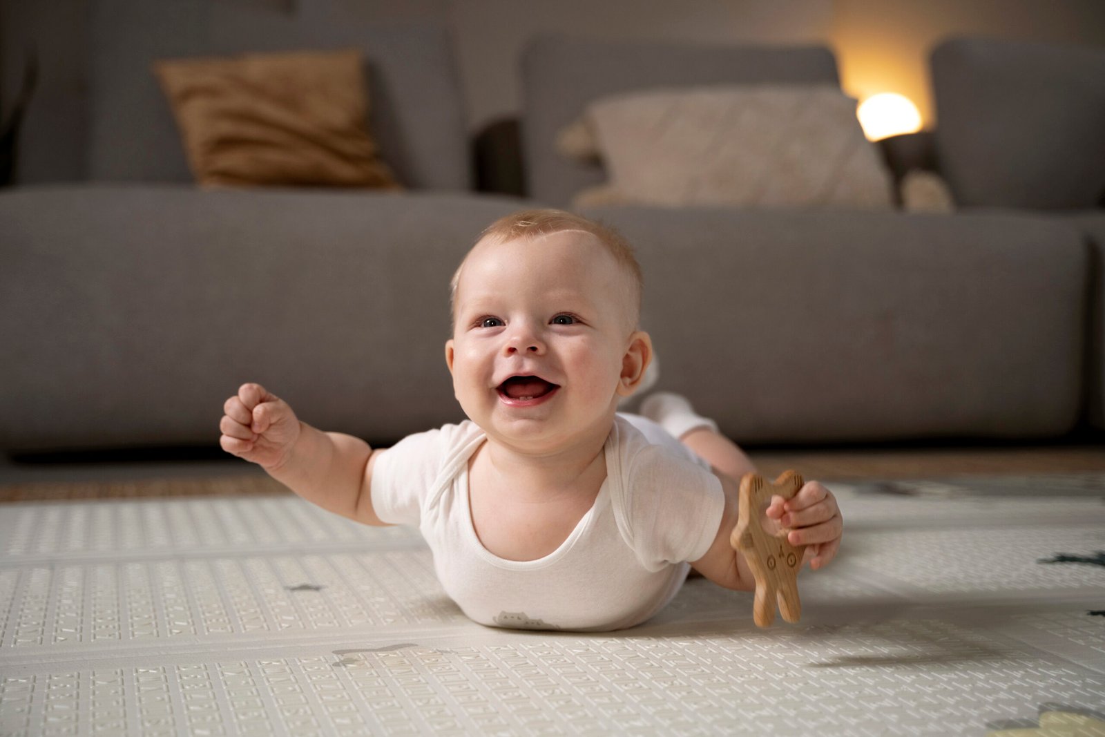 Baby practising tummy time on a play mat to build rolling skills
